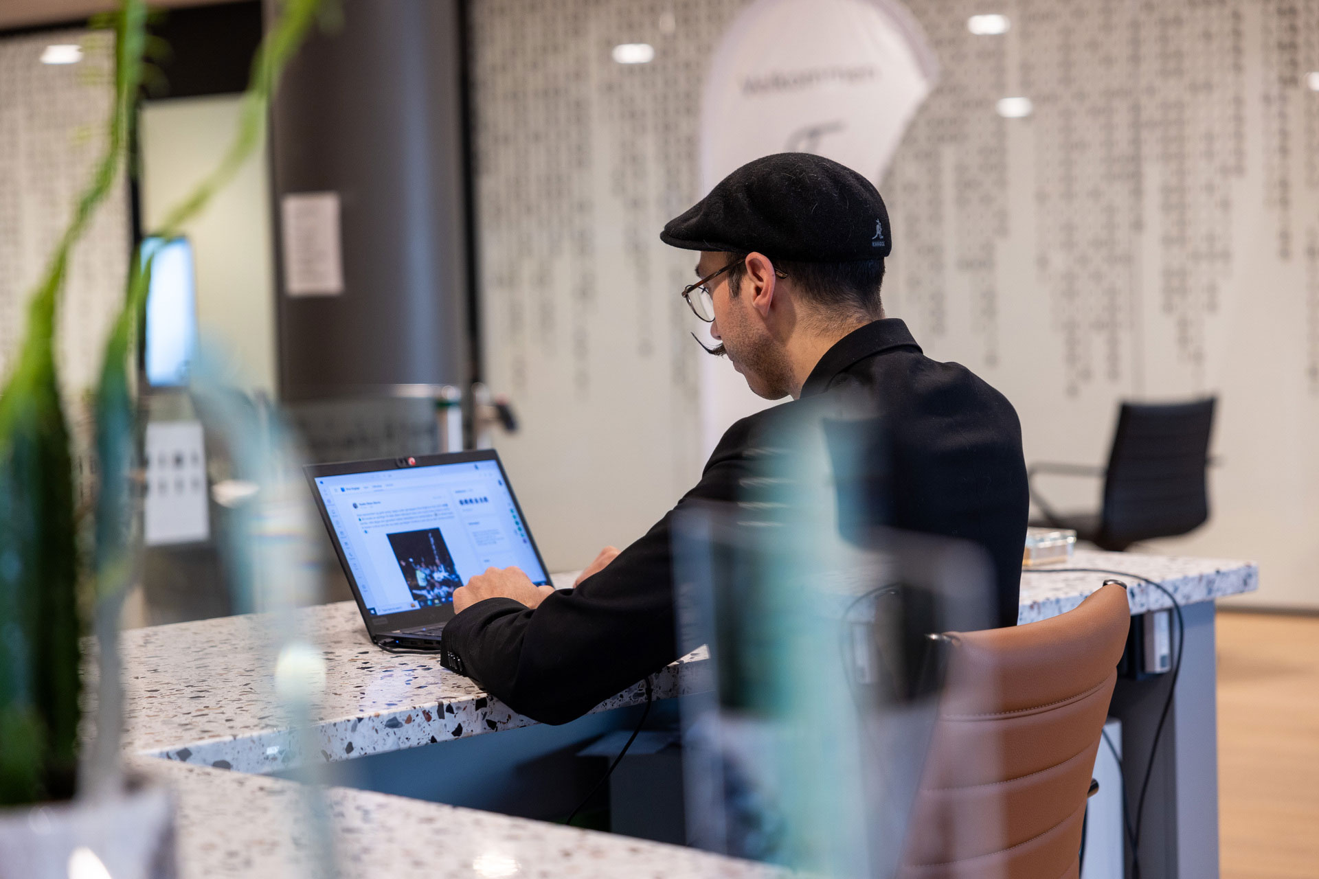 Man Sitting At Desk Working On Computer